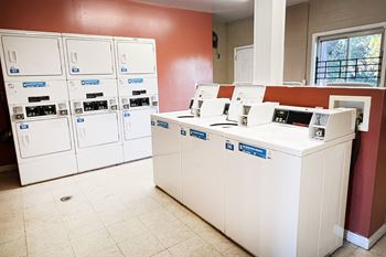 A bank with a white counter and a red wall.